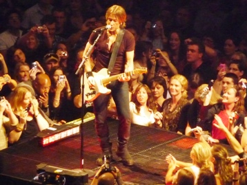 Keith Urban performing on a small stage at the back of Rod Laver Arena, Melbourne. Photo by Steve Yanko.